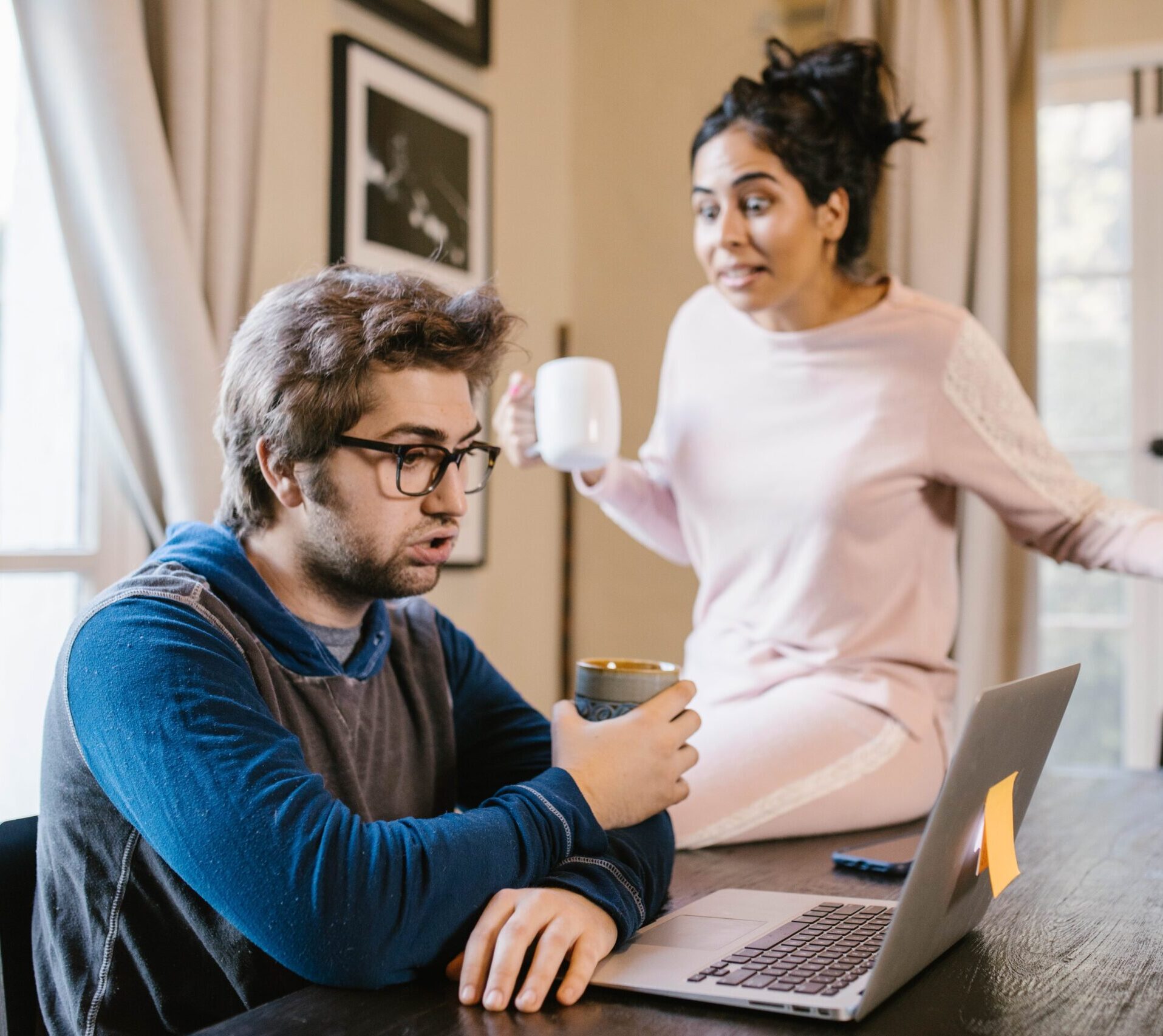 Wife yelling at husband while he is on his laptop