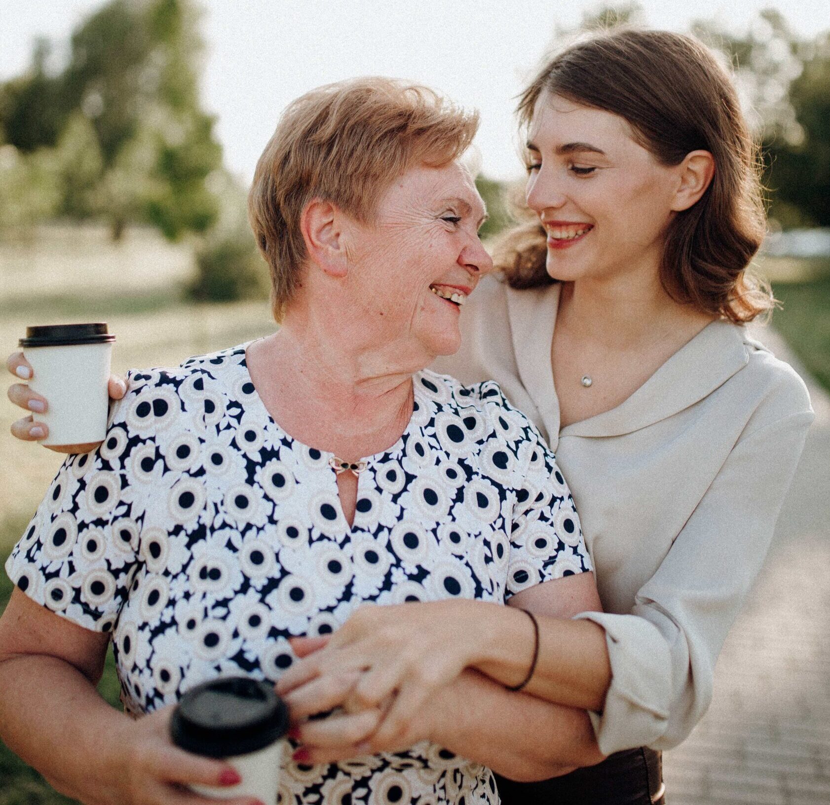 Woman laughing and hugging her elderly mother